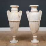 A pair of alabaster lamps formed as classical volute jars, with fluted sides and scroll handles