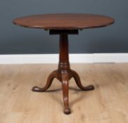 A George III mahogany circular tilt top occasional table, with box support to the circular table