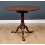 A George III mahogany circular tilt top occasional table, with box support to the circular table