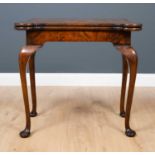 A mid to late 18th century burr walnut tea table with cabriole front legs and pad feet, 78cm wide