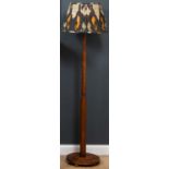 An early 20th century oak art deco lamp standard with stepped column and circular spreading base,