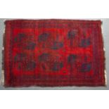 An Afghan red ground rug 183cm x 126cm and a further Middle Eastern red ground rug, 280cm x 86cm (