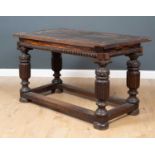 A 17th Century and later oak refectory table with corinthian column supports and marquetry edges,