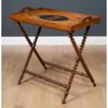 A Victorian olive wood tray complete with folding bobbin turned stand, the quarter veneered tray