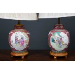 A pair of Chinese porcelain famille rose lidded jars formed as table lamps, decorated with panels