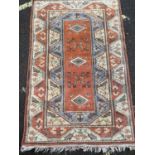 A Turkish orange and cream ground woollen rug with geometric decoration, 124cm x 196cmCondition