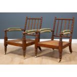 A pair of early 20th century Art and Crafts caned bobbin turned armchairs, with green and white