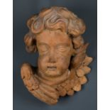 After Grinling Gibbons, a limewood carved head of a cherub, possibly from an altarpiece, 22cm wide x