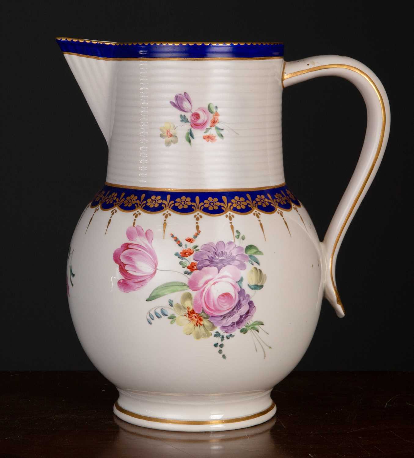 A late 18th century Royal Crown Derby ale jug, with blue and gilt decoration and central floral