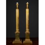 A pair of brass table lamps of classical column form with fluted columns and square plinth bases,