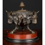 A 19th century circular bronze ink stand with three bulls heads on three cloven hooved supports