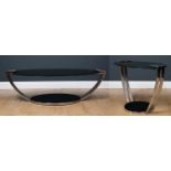 Two contemporary chrome plated black glass topped oval occasional tables the largest 120cm long x