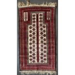 An antique blue and red ground Middle Eastern rug 102cm x 167cm; a further red ground rug, 155cm x