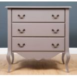 A grey painted chest of three drawers with shaped frieze and short cabriole legs, 91.5cm wide x 51cm