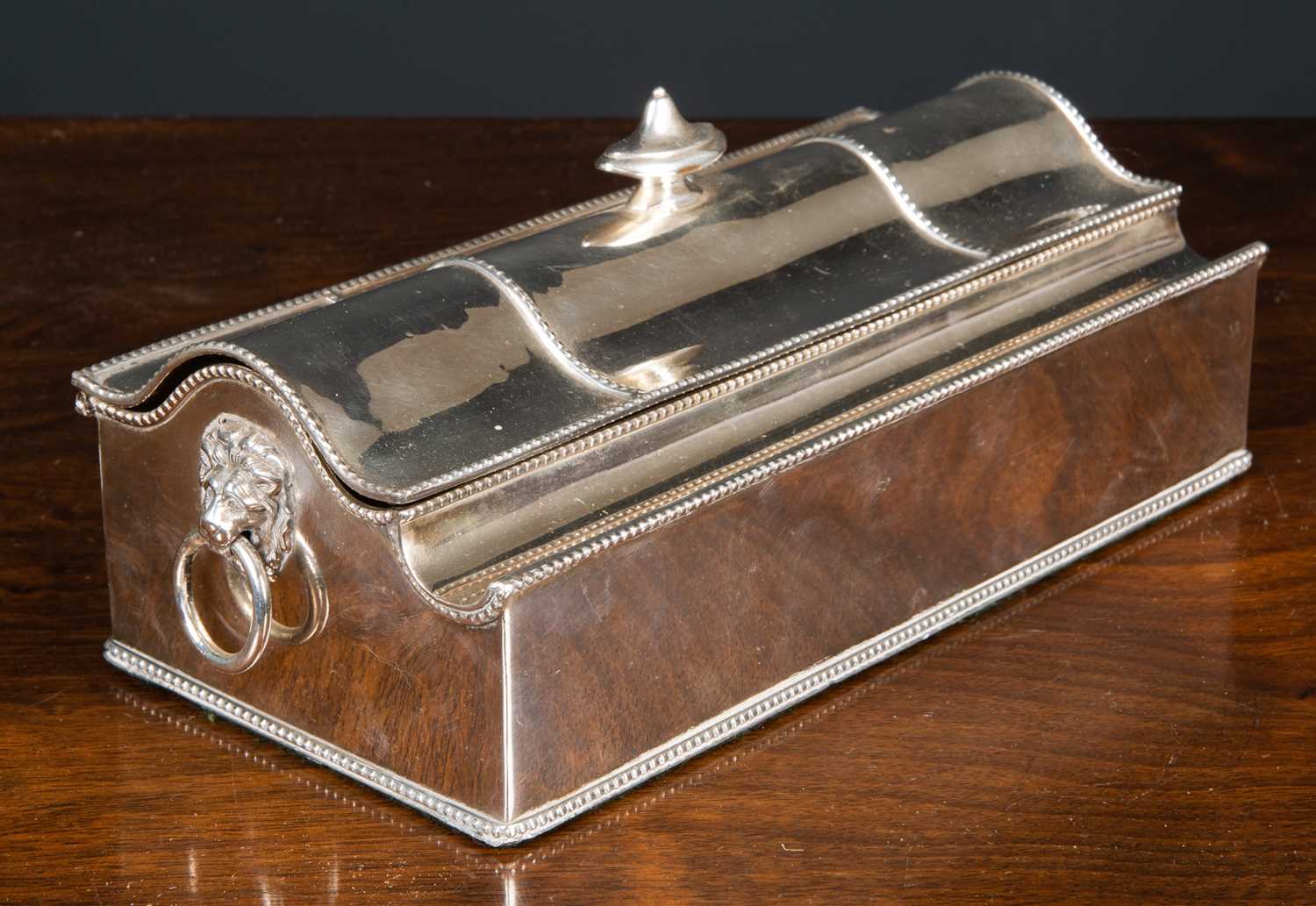 A 19th century silver plated casket form desk stand, containing two cut glass and silver plated