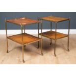 A pair of brass two tier occasional tables with leather inset tops to the two tiers, all on brass