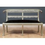 An Eastern pressed metal mounted settee with rams head finials and upholstered seat, 147cm wide x