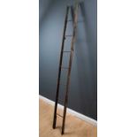 A 19th Century oak and wrought iron folding library ladder previously painted green and with wrought