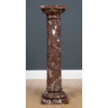 A brown marble pedestal on a column with turned base and square plinths, 24cm wide x 24cm deep x