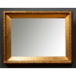 A rectangular carved giltwood mirror, with wreath effect edge, 79cm wide x 8cm deep x 59cm