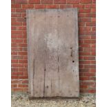 An antique heavy wooden country cottage door with iron studs and hinged brackets, 90cm wide x 164.