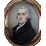 A George III portrait miniature of a gentleman with grey hair, white stock and wearing a black