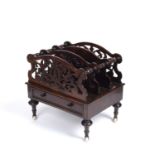 A Victorian rosewood music canterbury with three pierced and one solid and shaped divisions, base