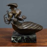 A small bronze dish with a dragon perched on the edge of a shell, later mounted on a marble base,