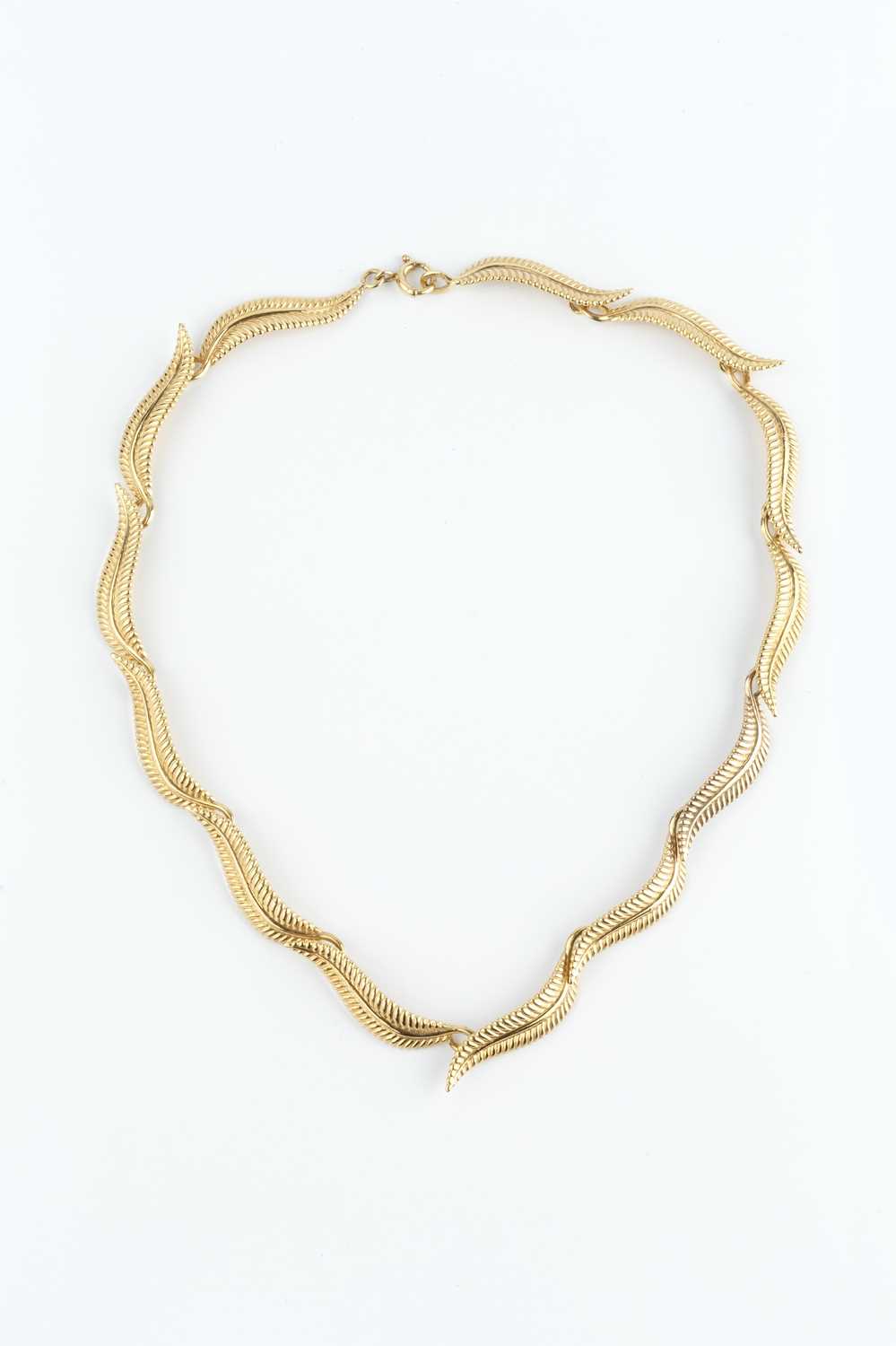 A 9ct gold collar necklace, designed as a series of repeating leaf panels, maker's mark EFC,