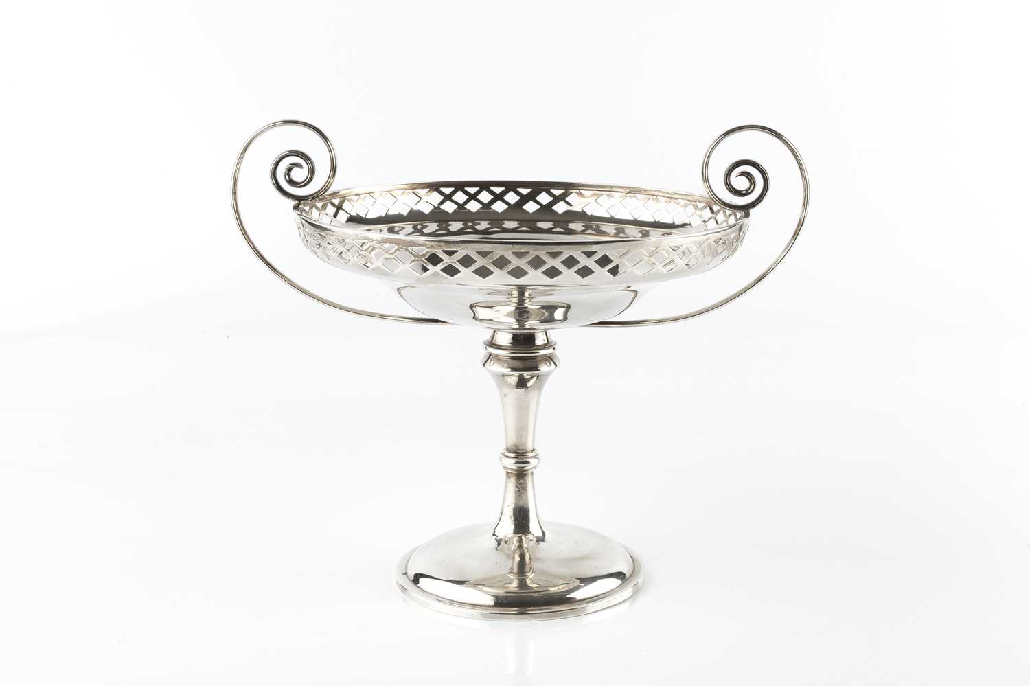 A silver twin-handled tazza, with lattice pierced border, and scroll handles, on circular pedestal