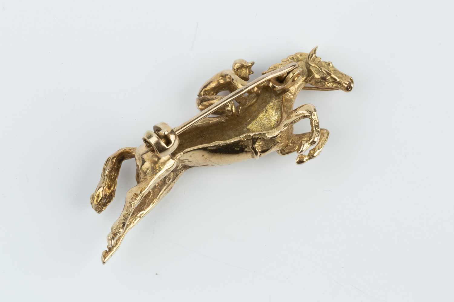 A 9ct gold horse and jockey brooch by Harriet Glen, modelled as a jumping racehorse, signed and - Image 2 of 2