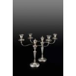 A pair of George III silver three light candelabra, the detachable branches with reeded drip pans,