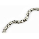 A white precious metal fancy-link bracelet, designed as a series of repeating ovoid links,