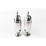 A pair of silver sugar castors, of octagonal faceted form, by Lee & Wigfull, Sheffield 1913, 17.