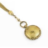 An early Victorian locket pendant, of circular engine-turned form, with hinged compartment and