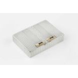 An American silver Art Deco style rectangular compact, with reeded and chevron banded decoration,