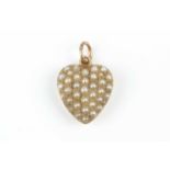 A late Victorian/Edwardian half pearl heart pendant, pavé set with graduated half pearls (untested