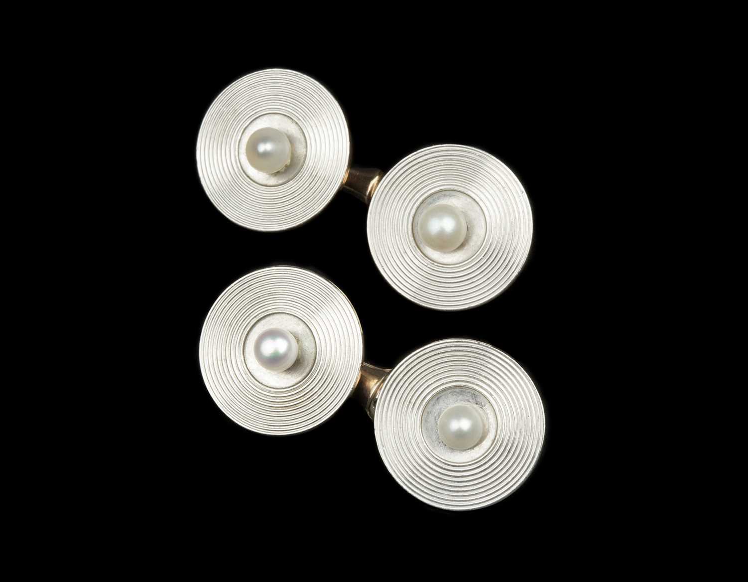 Of Ian Fleming interest: A pair of cultured pearl set cufflinks, each circular panel with radial