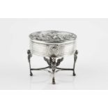 An early 20th century Continental silver circular trinket box, the hinged cover embossed with a