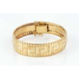 A yellow precious metal bracelet, of Greek key design and part-textured finish, stamped '750',