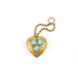 A Victorian turquoise set memorial pendant, the heart-shaped pendant engraved with foliate scrolls