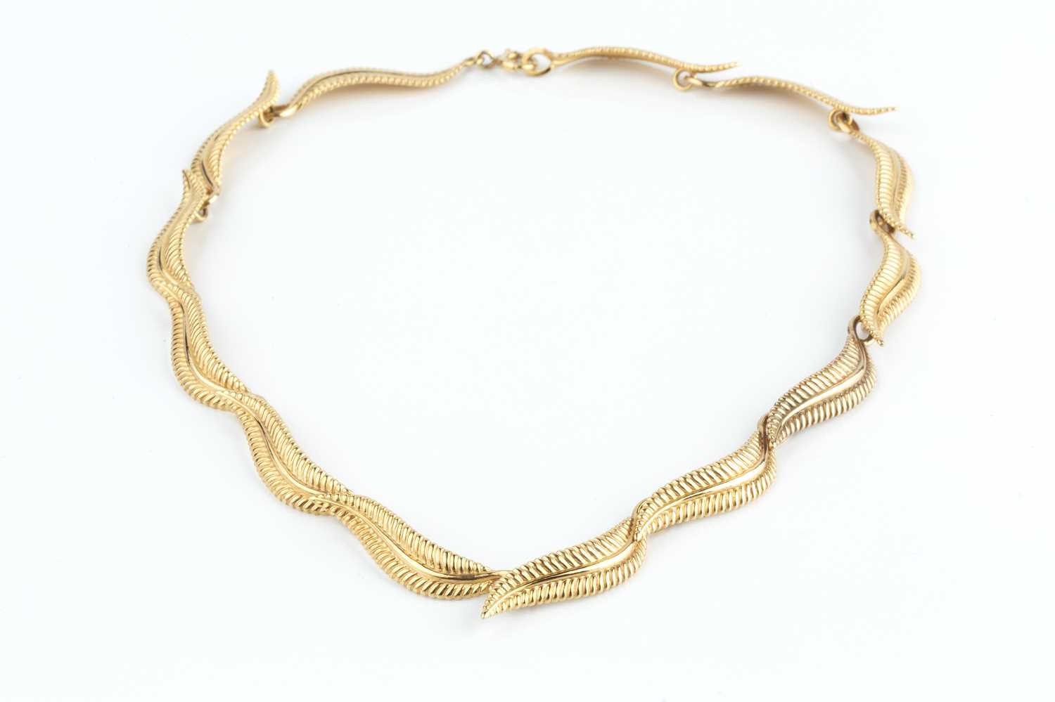A 9ct gold collar necklace, designed as a series of repeating leaf panels, maker's mark EFC, - Image 2 of 3