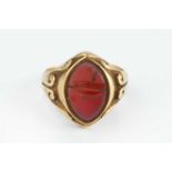 A Victorian signet ring, with scrolled decoration, centred with a navette-shaped hardstone panel (