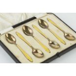 A set of six silver and yellow enamel tea spoons, by Barker Bros Silver Ltd., Birmingham 1936, in