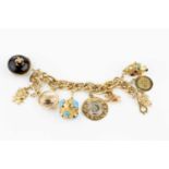 A charm bracelet, the yellow precious metal fancy curb-link bracelet suspending a collection of