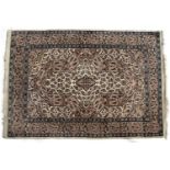 Cream ground rug with diamond shaped central medallions with botheh within a foliate border, 184cm x