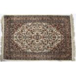 Cream ground rug with central foliate and floral design within a pale pink border, 149cm x