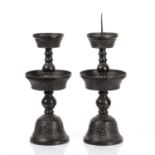Pair of bronze Ming style temple candlesticks Chinese, 19th Century modelled as a ribbed and bulbous