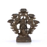 Temple oil lamp Nepalese, 19th Century depicting a male kneeling, surrounded by five oil holders,