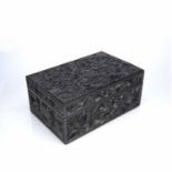 Carved ebony box Ceylonese, 19th Century the trailing foliate carving covering the top and sides,